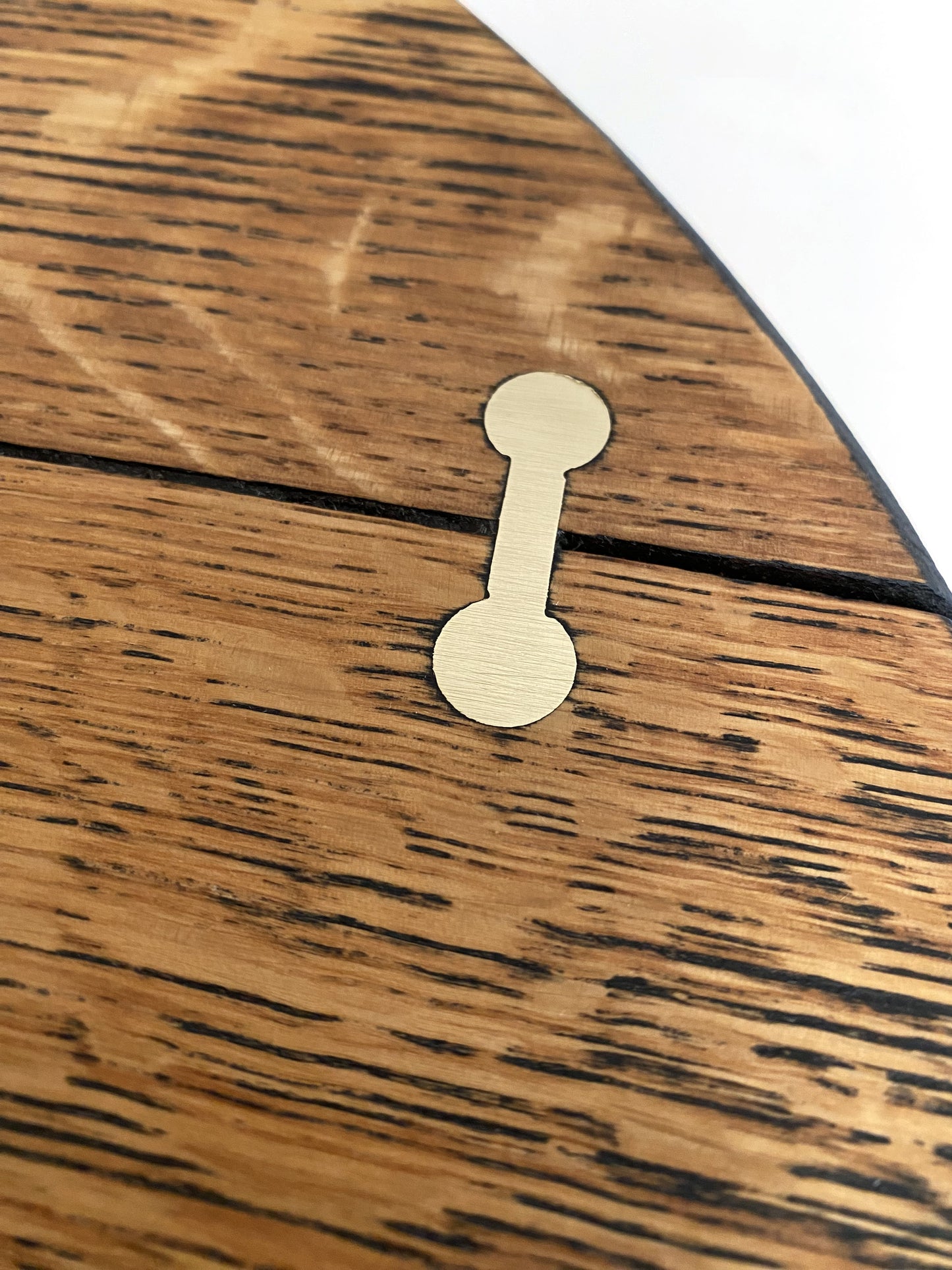 Modern rustic mid-century coffee table with traditional brass barbell joinery and natural oak grain surface texture