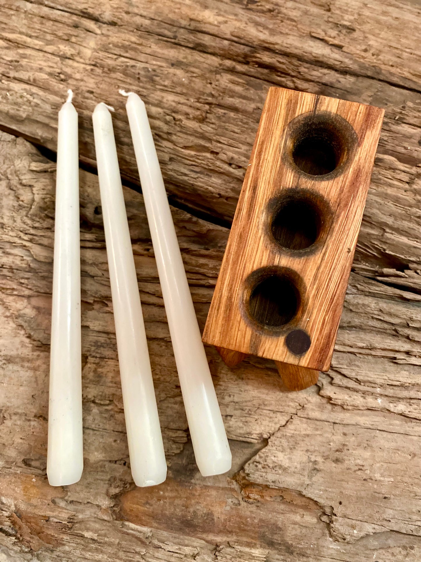 Handcrafted candle holder for three tall candles, made from aged whisky barrel oak. Combines rustic texture with sleek design, ideal for ambient lighting or as a sustainable, stylish gift