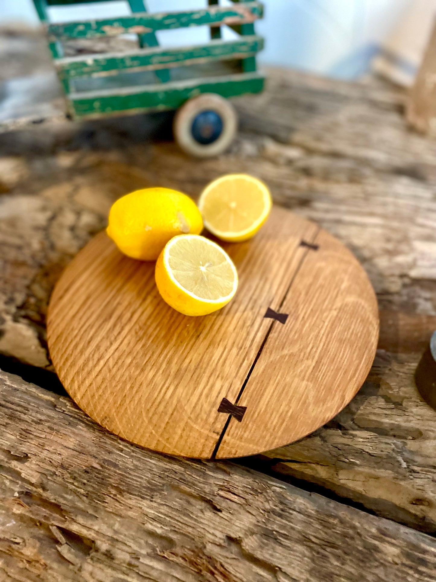 Round cutting serving tray board made with reclaimed oak with traditional walnut bowtie joinery