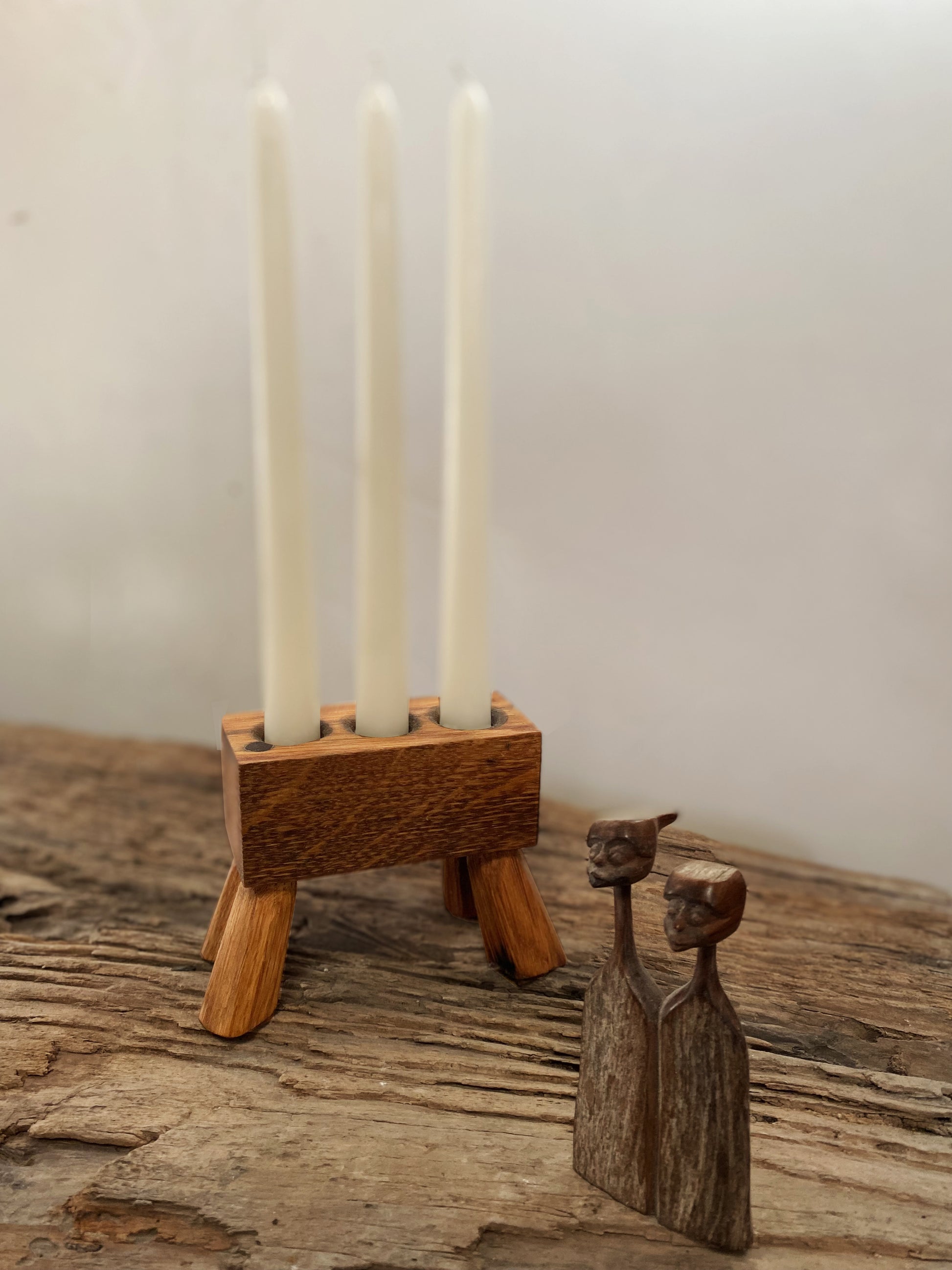 Rustic reclaimed oak triple-candle holder, handcrafted with precision from whisky barrels. A perfect centerpiece or ambient lighting accent, bringing warmth and sustainability to your home