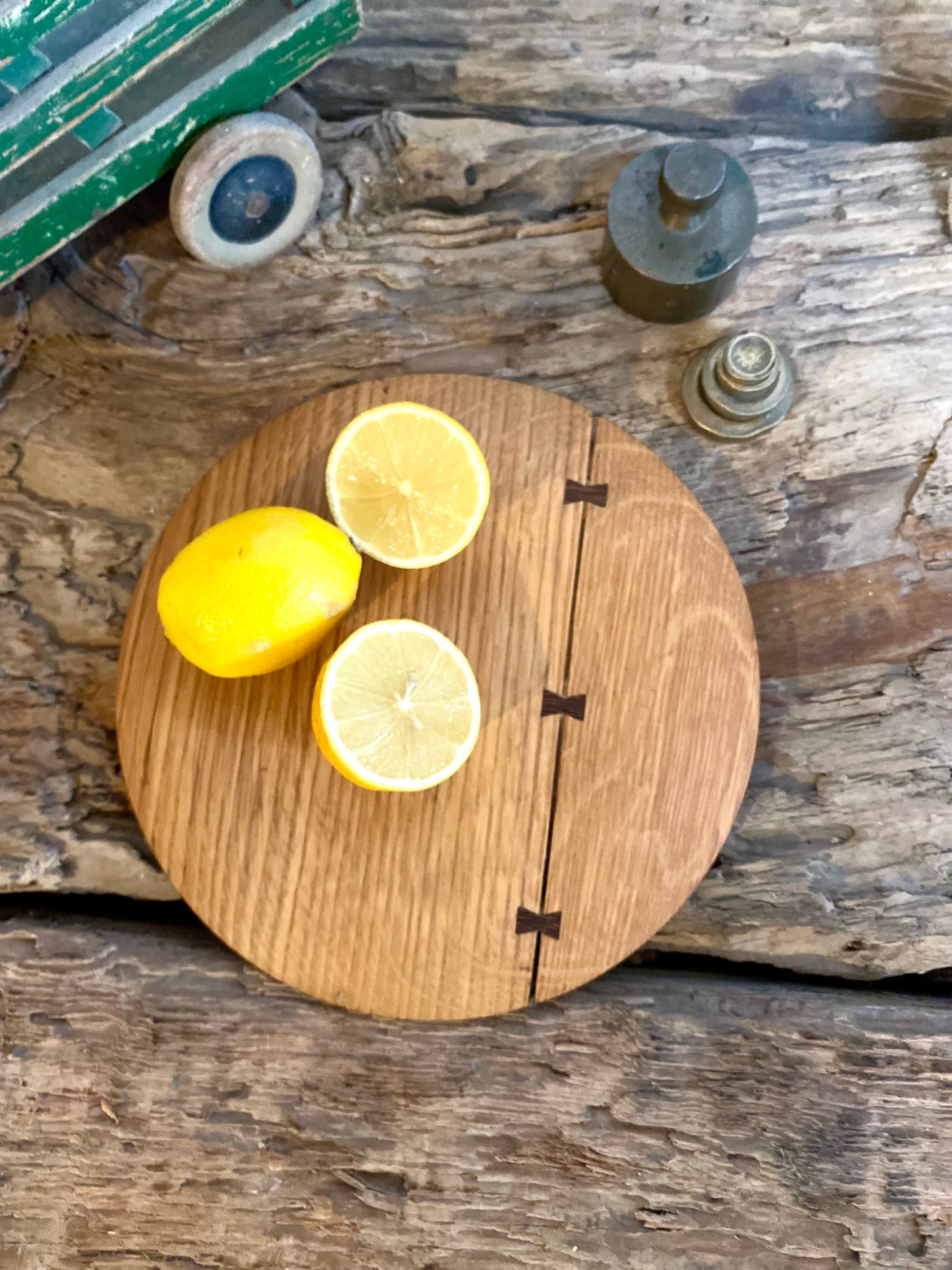 Round cutting serving tray board made with reclaimed oak with traditional walnut bowtie joinery
