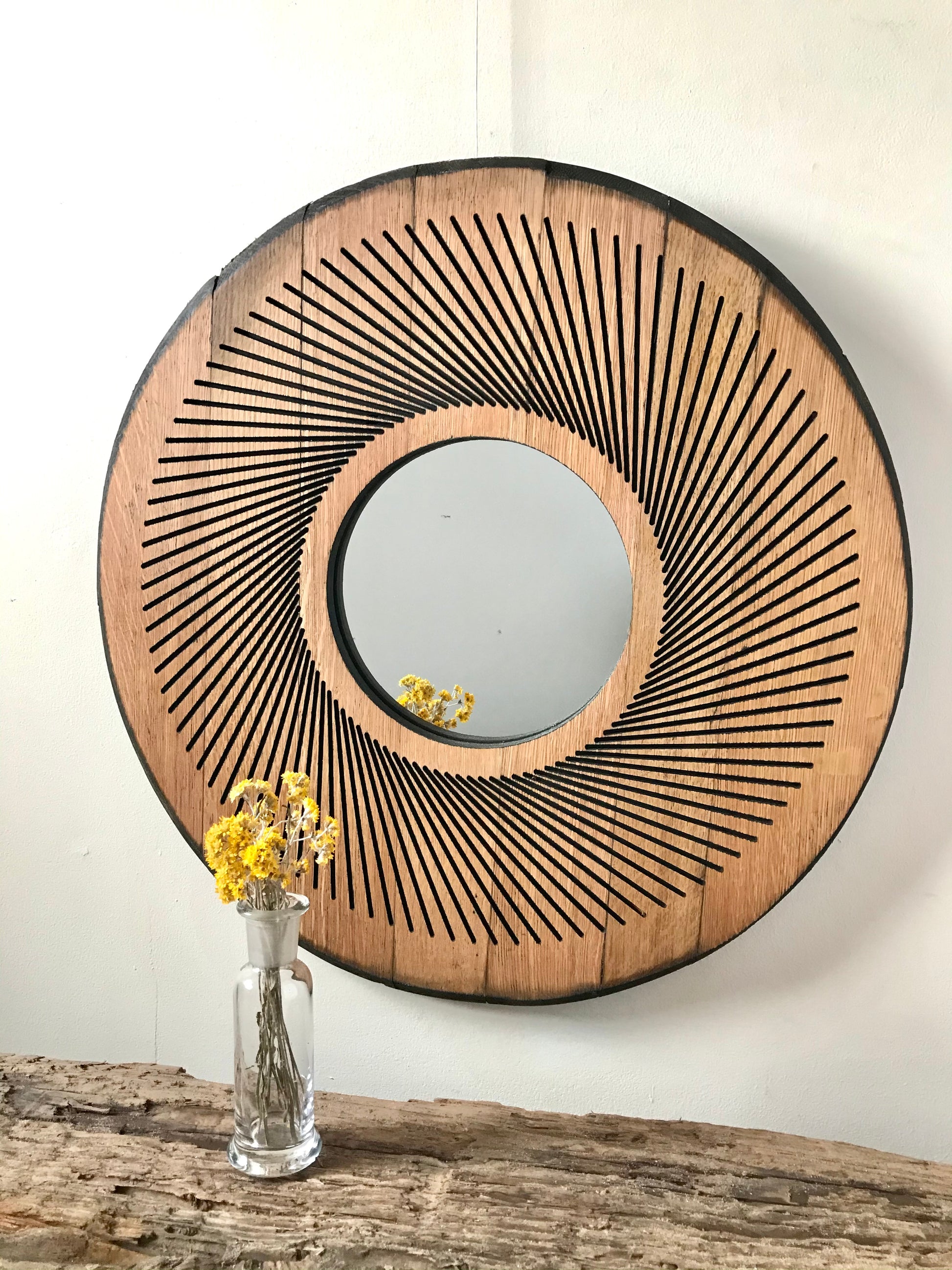 Rustic geometric oak mirror crafted from reclaimed whisky barrels, featuring radial design and natural wood patina. Sustainable and stylish for gallery walls or cozy interiors