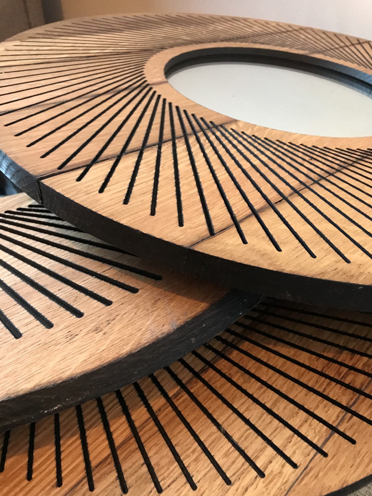 Circular oak mirror featuring a stunning sacred geometry radial design, crafted from an upcycled Scottish whisky barrel lid. Perfect for adding eco-friendly elegance to any space